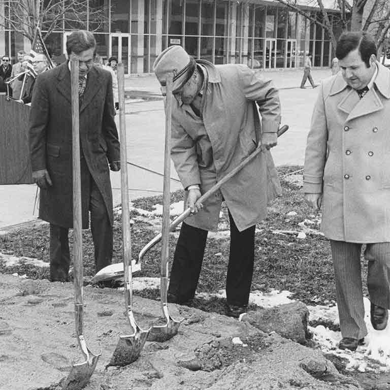 Dignitaries break ground on the Taylor Courtyard on a cold winter day. Black and white photo.