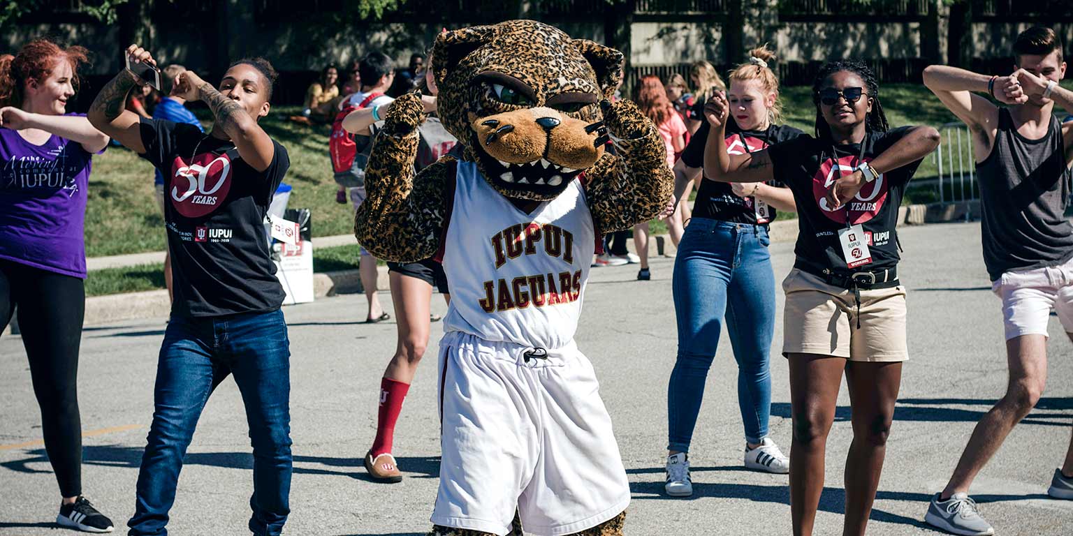 Students dance with Jawz the Jaguar mascot between acts during the Talent Showcase.