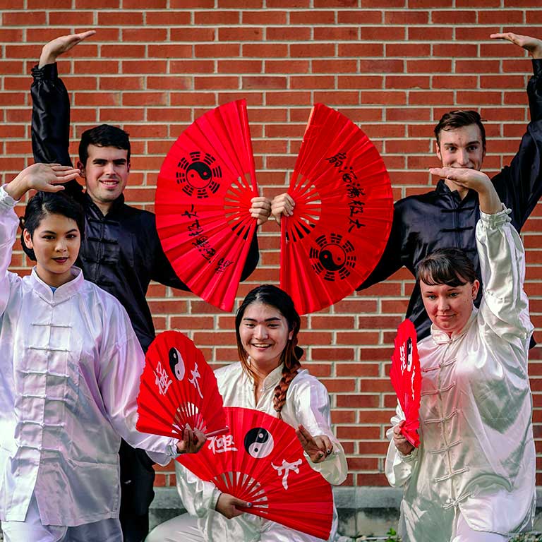Students from the Chinese Cultural Club at IUPUI pose with their red fans.
