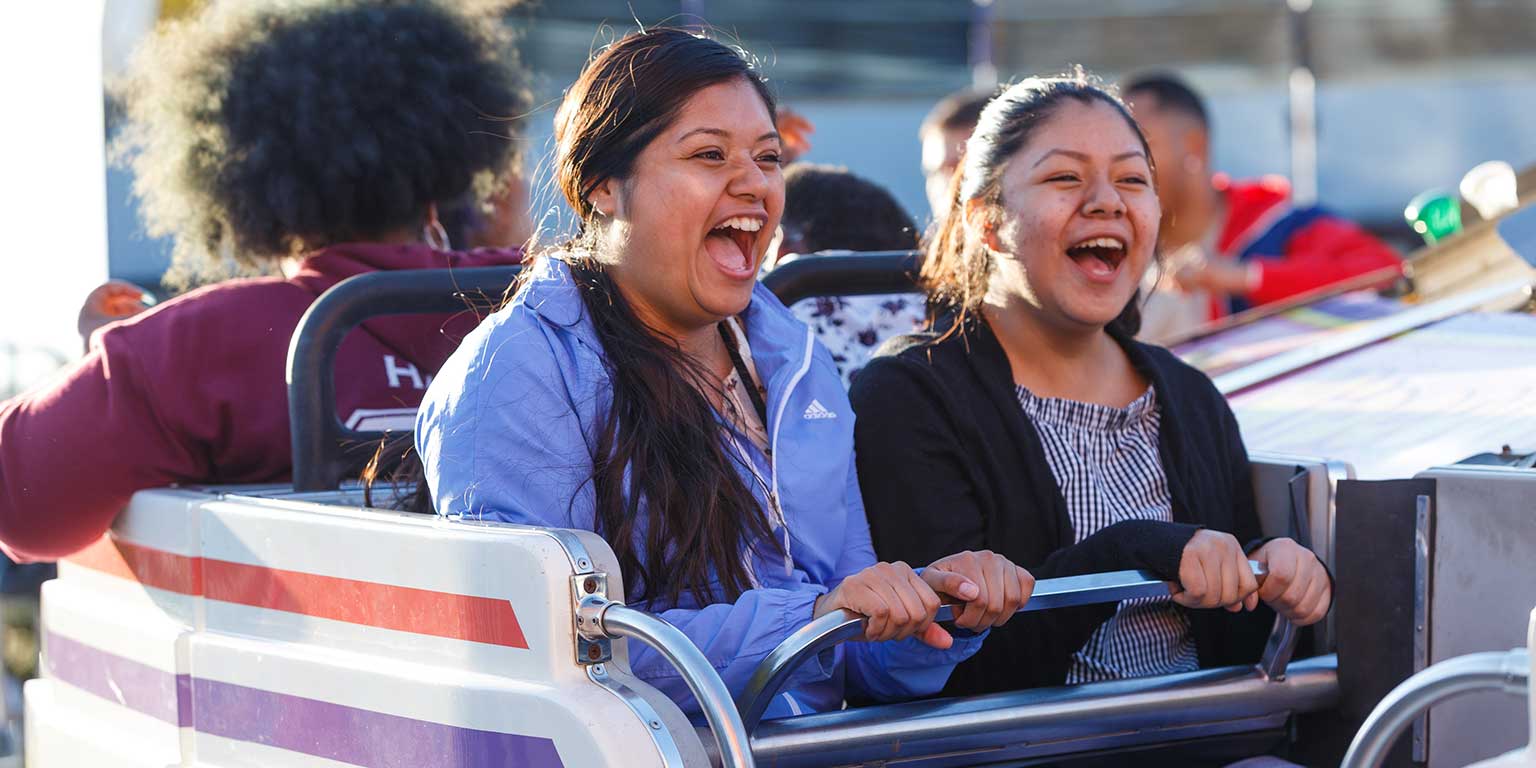 Students laugh while on a ride at Jagapalooza.
