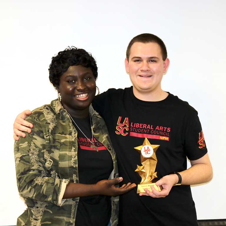 Logan Bromm receives an award during the Liberal Arts Student Council Awards.