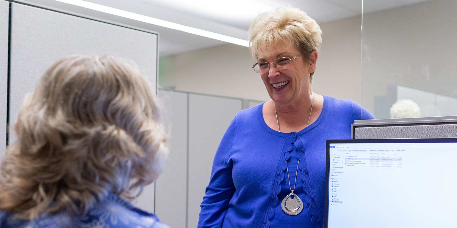 Linda Durr chats with a colleague in the Office of Planning and Institutional Improvement.
