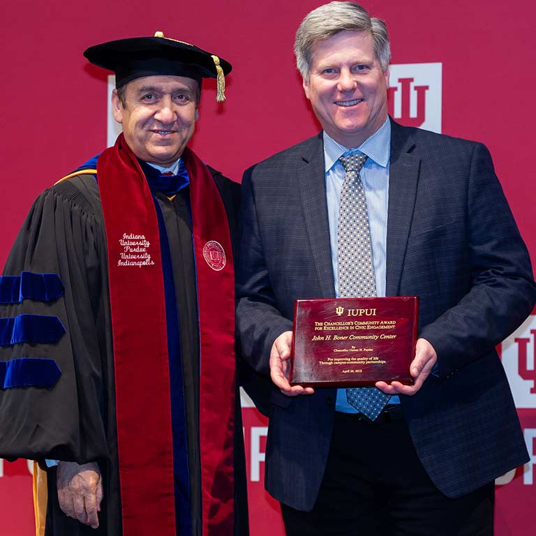 James Taylor receives the Chancellor's Community Award for Excellence in Civic Engagement from IUPUI Chancellor Nasser Paydar in 2018.