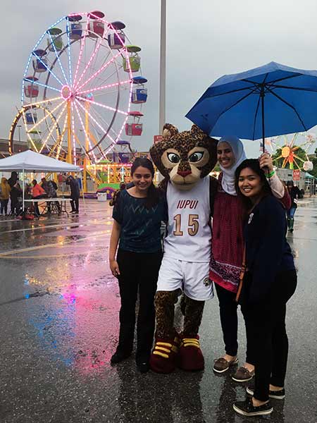 Amira Nafiseh with her friends and the jaguar mascot Jazzy at Jagapalooza