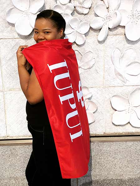 Attiya White wearing an IUPUI flag