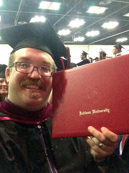 Ben Risinger with his diploma during Commencement